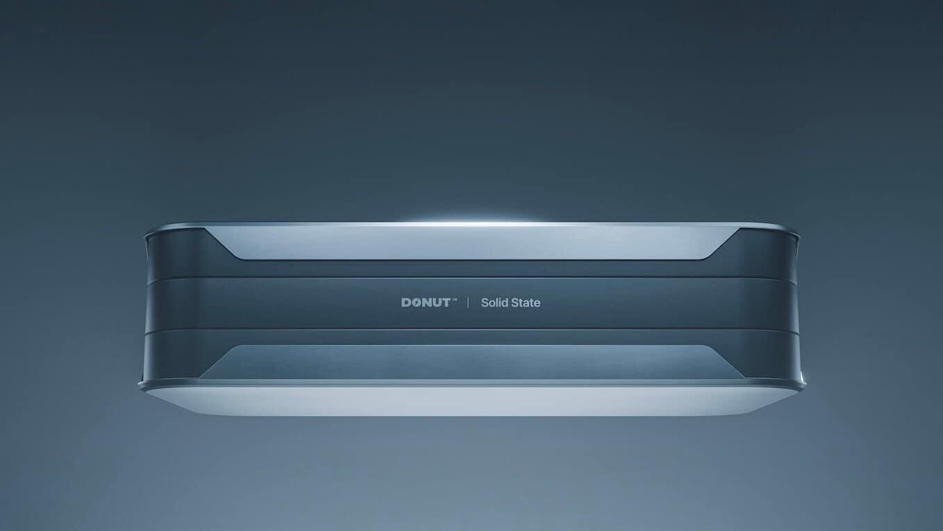A sleek, rectangular electronic device labeled "DONUT <br /> Solid State" is shown against a plain, gradient blue background, viewed from a slightly lower front angle.